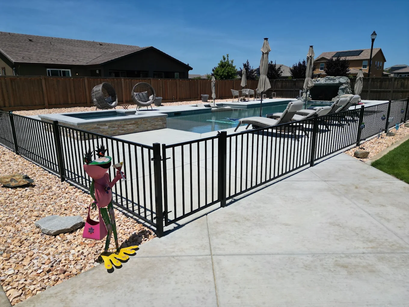 Concrete pool deck with safety fencing